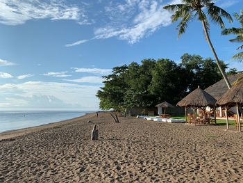 Scenic view of beach by sea against sky