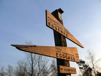 Low angle view of information sign against sky