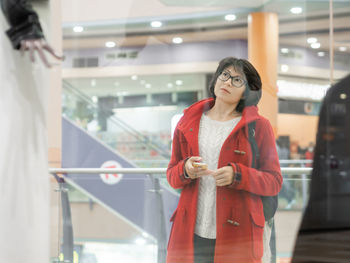 Woman stares on dummies in clothing store. casual outfit hanging on mannequins. shopping at mall. 