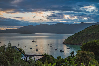 Scenic view of sea and mountains against sky