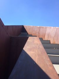 Low angle view of wall against blue sky