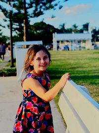 Portrait of smiling girl standing outdoors