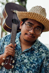 Portrait of young man playing guitar