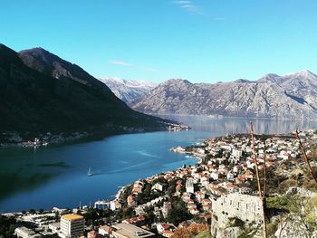 Scenic view of lake and mountains against blue sky