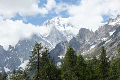 Scenic view of mountains against cloudy sky