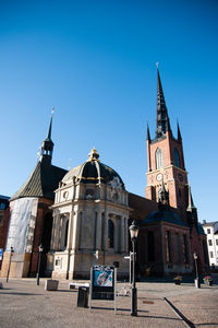 Low angle view of building against clear blue sky