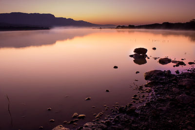 Scenic view of lake against sky during sunset