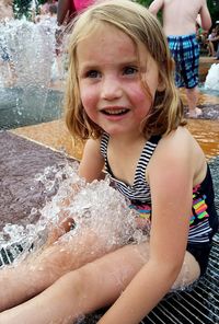 Portrait of happy girl in swimming pool