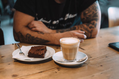 Midsection of a man enjoying coffee