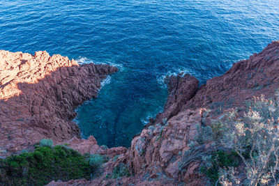 High angle view of rock formation in sea