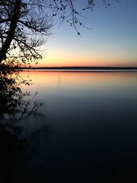 Scenic view of lake against clear sky at sunset