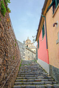 Alley amidst buildings against sky