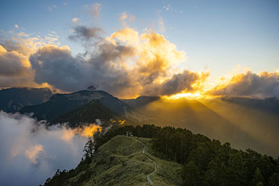 Scenic view of mountains against sky at sunset