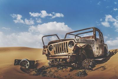 Abandoned vehicle against sky