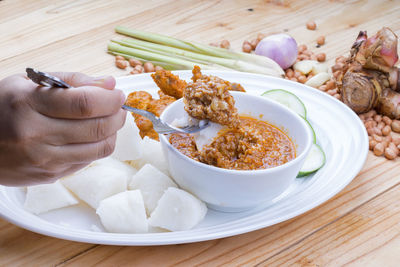 High angle view of person having breakfast on table