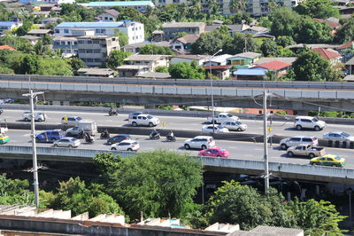 High angle view of vehicles on road along trees