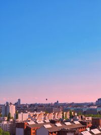 High angle view of buildings against clear blue sky