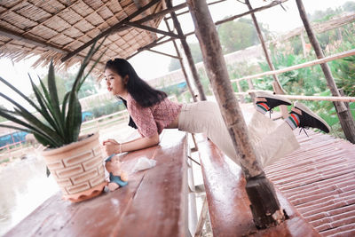 Side view of young woman relaxing outdoors