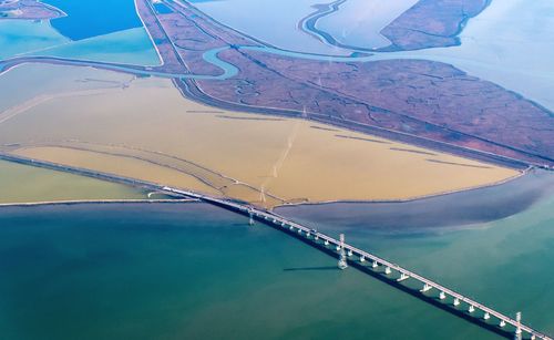 Swimming pool by sea against sky