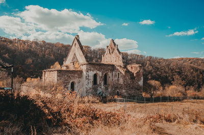 Old ruined fortress in woods. blue sky with white clouds. beautiful picture for puzzles.