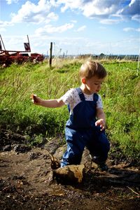 Rear view of a girl standing on field