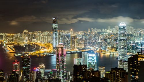 Illuminated cityscape against sky at night