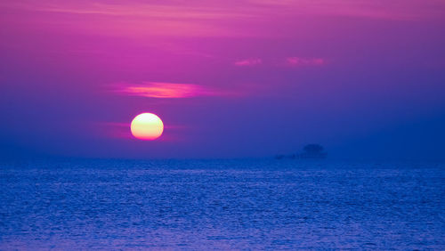 Scenic view of sea against romantic sky at sunset