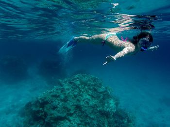 Young woman snorkeling undersea