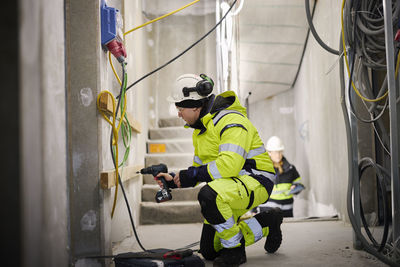 Construction worker using electric drill