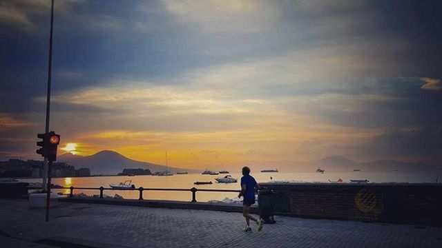 sunset, sky, cloud - sky, water, scenics, transportation, sea, lifestyles, tranquility, men, beauty in nature, orange color, silhouette, cloud, leisure activity, full length, tranquil scene, nature