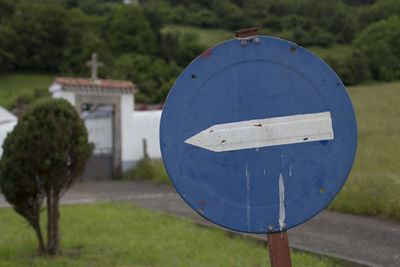 Close-up of road sign on field