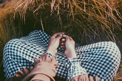 Low section of woman relaxing on grass