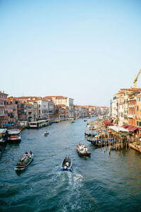 Boats in canal along buildings