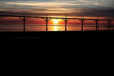 Scenic view of silhouette bridge against sky during sunset