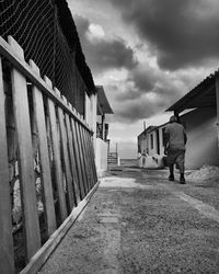 Man standing on railroad track against sky