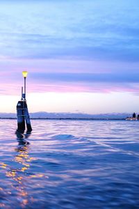 Reflection of clouds in sea at sunset