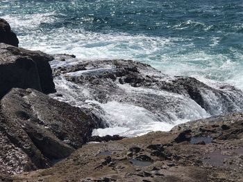 Scenic view of rocks at sea shore