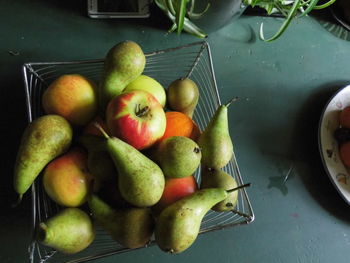 High angle view of various fruits in container on table