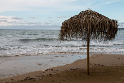 Parasol on beach against sky