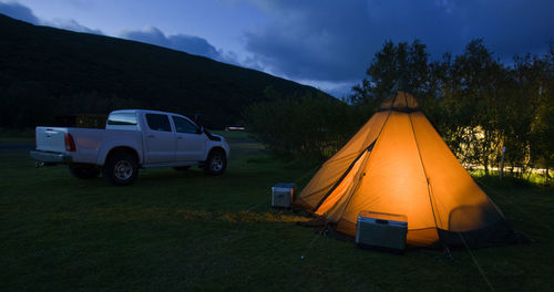 Illuminated tent on campsite in iceland