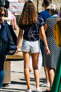 Rear view of people standing outdoors