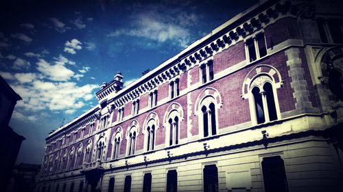 Low angle view of building against cloudy sky