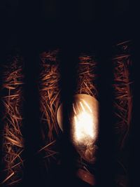 Close-up of illuminated lighting equipment against black background