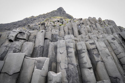 Low angle view of castle on mountain against sky