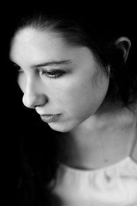 Close-up portrait of young woman looking away