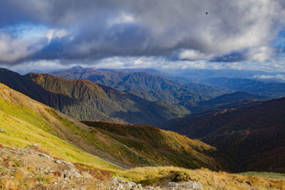 Scenic view of mountains against cloudy sky