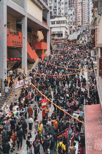 High angle view of people on street against buildings in city