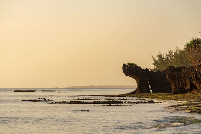 Scenic view of sea against clear sky during sunset