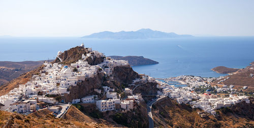 High angle view of townscape by sea against sky