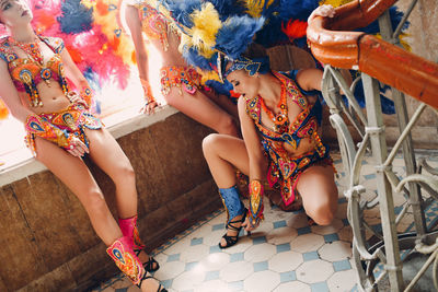 High angle view of people sitting on multi colored umbrellas